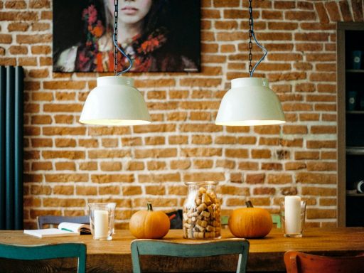 rectangular brown wooden table with two pumpkin on top