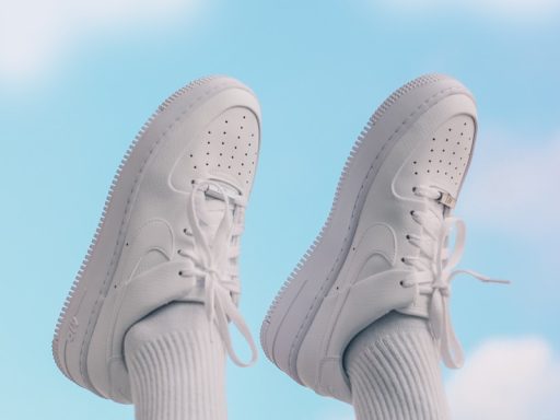 person wearing white nike sneakers
