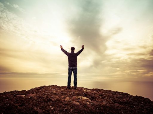 man standing under orange sky