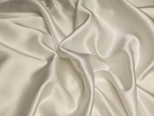 Soft folds of white silk fabric with a smooth and lustrous surface